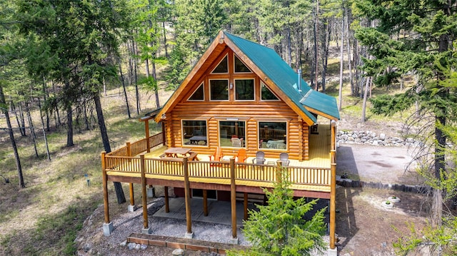 148 Muley Rd, Lakeside, MT 59922 - back of house with log siding, a deck, a patio, and metal roof