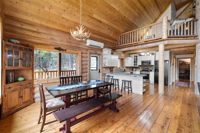 148 Muley Rd, Lakeside, MT 59922 - dining space with light wood-style flooring, a wall unit AC, log walls, an inviting chandelier, and wood ceiling