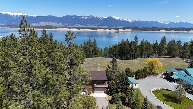 drone / aerial view featuring a water and mountain view