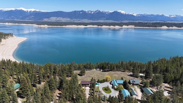 bird's eye view with a water and mountain view and a wooded view