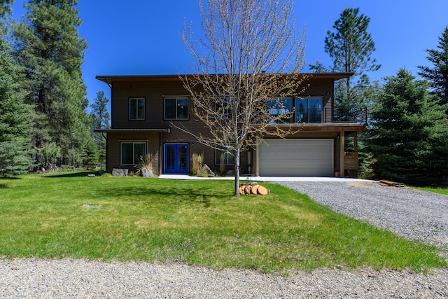 traditional-style house featuring an attached garage, a front lawn, french doors, and gravel driveway