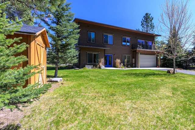 282 Mountain View Rd, Rexford, MT 59930 - back of property with a garage, a yard, a balcony, and driveway