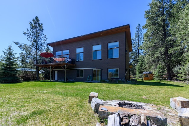back of house with a wooden deck and a lawn