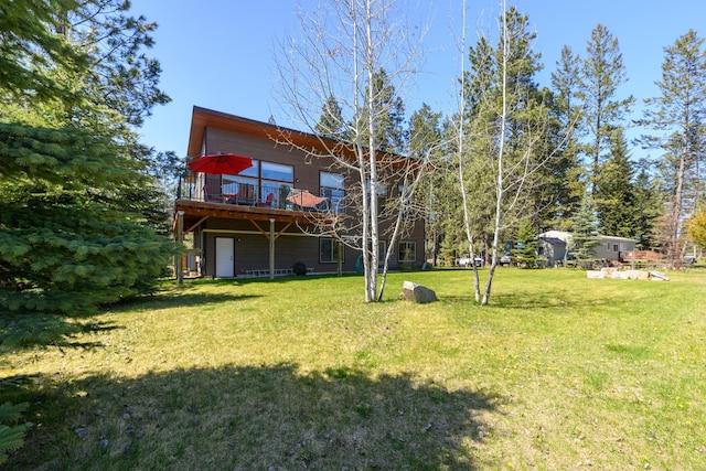 rear view of property with a deck and a lawn