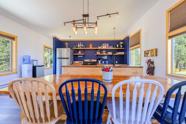 282 Mountain View Rd, Rexford, MT 59930 - kitchen featuring freestanding refrigerator, open shelves, rail lighting, blue cabinetry, and wood finished floors