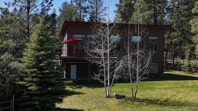 back of house featuring a yard and a wooden deck