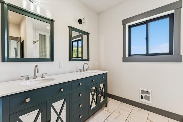 full bathroom featuring heating unit, double vanity, marble finish floor, and a sink