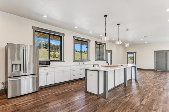 kitchen featuring dark wood finished floors, recessed lighting, white cabinetry, light countertops, and appliances with stainless steel finishes