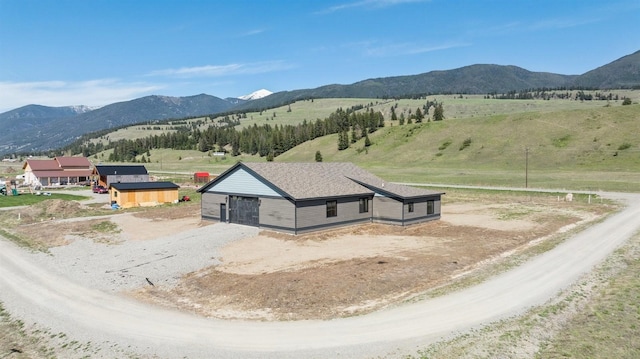 birds eye view of property with a rural view and a mountain view