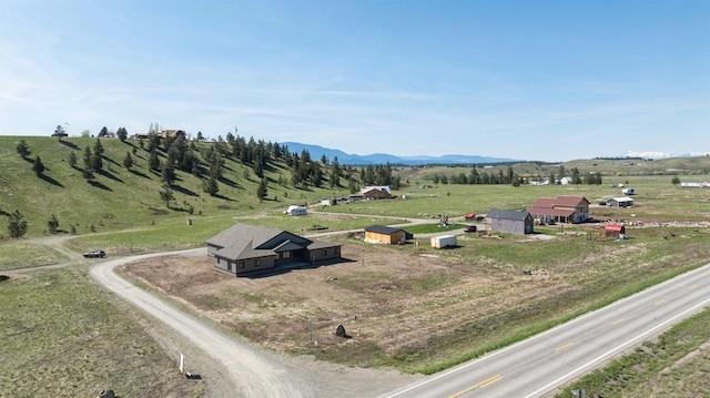 birds eye view of property with a mountain view and a rural view