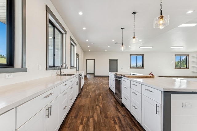 kitchen featuring a sink, recessed lighting, open floor plan, and dark wood finished floors