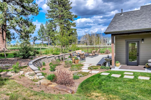 view of yard featuring a patio area, a fire pit, and fence