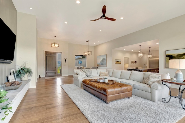 living area featuring ceiling fan, light wood-type flooring, and recessed lighting