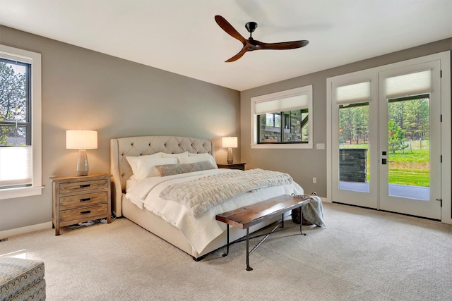 bedroom with baseboards, light carpet, a ceiling fan, and access to exterior