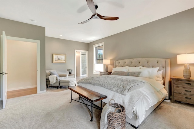 bedroom featuring baseboards, light carpet, and a ceiling fan