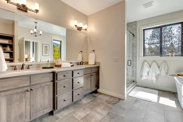 bathroom featuring double vanity, visible vents, a stall shower, and a sink