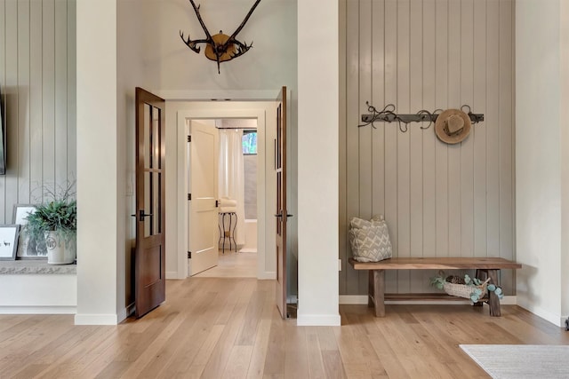 mudroom featuring baseboards and light wood-style floors