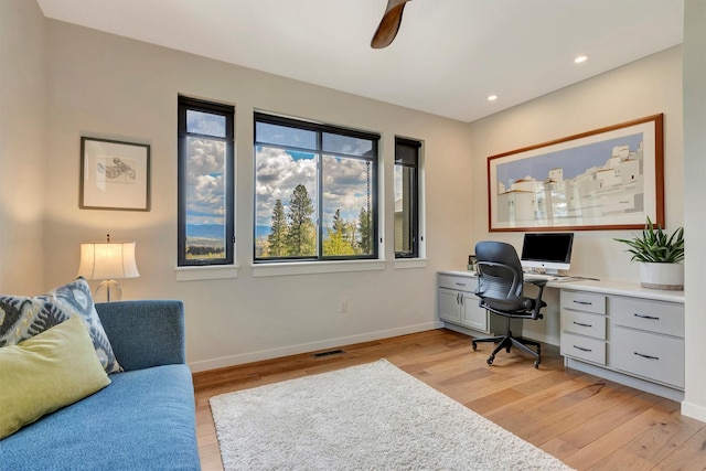 office featuring light wood finished floors, baseboards, and visible vents