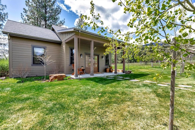 rear view of house featuring a yard