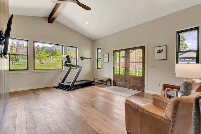 exercise room featuring french doors, light wood-type flooring, vaulted ceiling, a ceiling fan, and baseboards