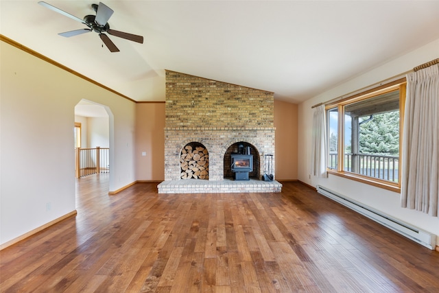6280 Alamosa Ln, Bozeman, MT 59718 - unfurnished living room featuring baseboard heating, ceiling fan, vaulted ceiling, a wood stove, and wood finished floors