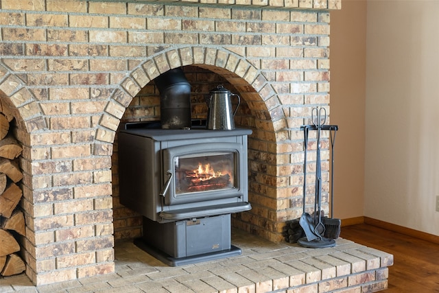 6280 Alamosa Ln, Bozeman, MT 59718 - room details with a wood stove, baseboards, and wood finished floors