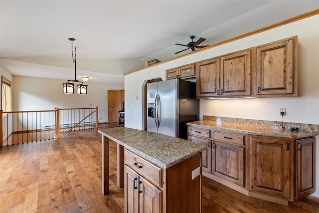 6280 Alamosa Ln, Bozeman, MT 59718 - kitchen featuring a center island, stainless steel fridge, a ceiling fan, lofted ceiling, and dark wood-style floors