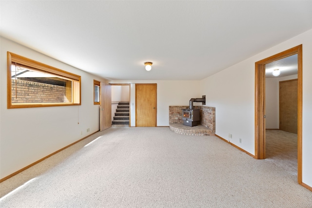 6280 Alamosa Ln, Bozeman, MT 59718 - interior space featuring a wood stove, carpet flooring, baseboards, and stairs