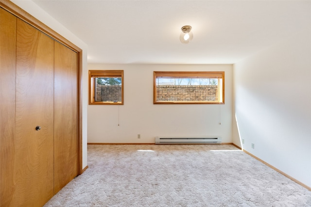 6280 Alamosa Ln, Bozeman, MT 59718 - carpeted empty room featuring baseboards, a healthy amount of sunlight, and baseboard heating