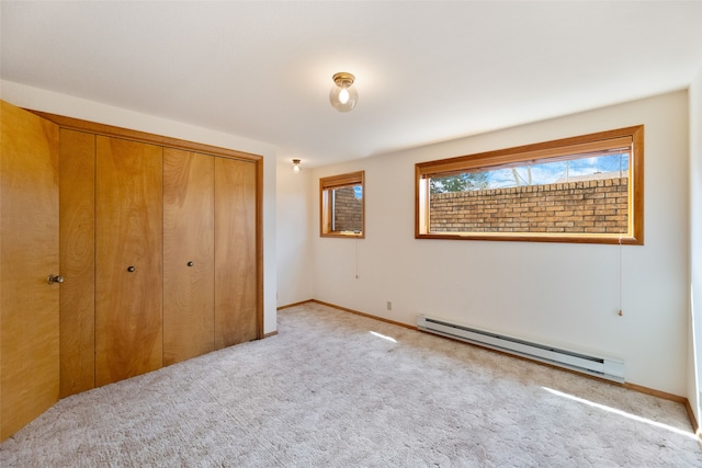 6280 Alamosa Ln, Bozeman, MT 59718 - unfurnished bedroom with baseboards, baseboard heating, a closet, and carpet floors