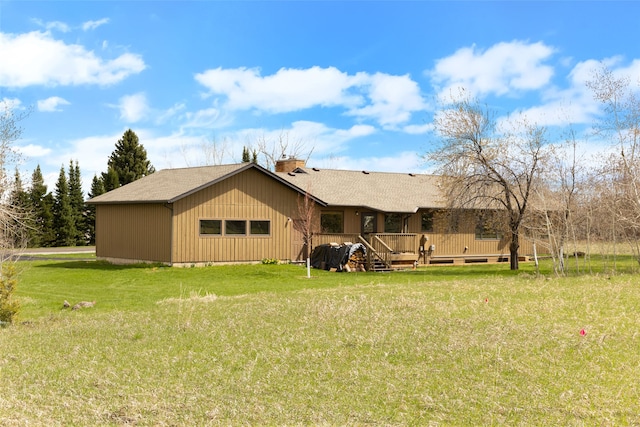 6280 Alamosa Ln, Bozeman, MT 59718 - back of house featuring a yard, roof with shingles, a deck, and a chimney