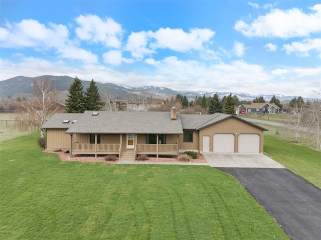 6280 Alamosa Ln, Bozeman, MT 59718 - view of front of home with covered porch, driveway, an attached garage, and a front yard