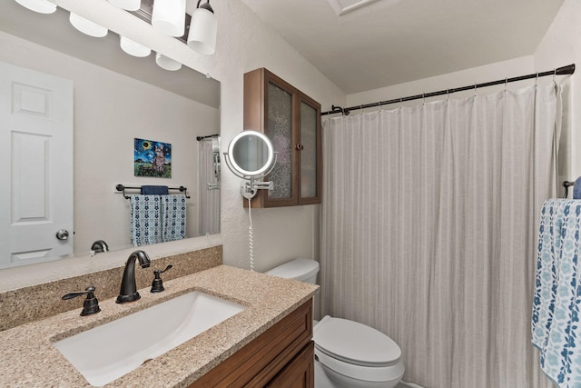 bathroom with toilet and vanity