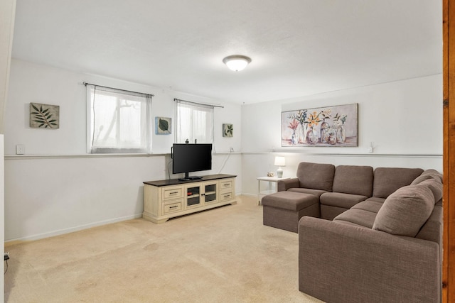 living room with baseboards and light carpet