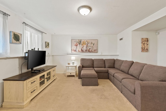 living area featuring light carpet and visible vents