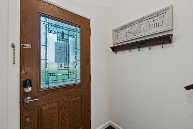 doorway to outside with baseboards
