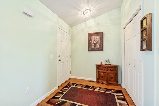 entrance foyer with baseboards and wood finished floors