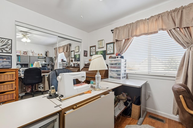 office featuring visible vents, wood finished floors, baseboards, and ceiling fan