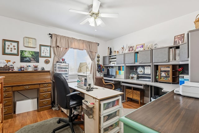 home office featuring light wood finished floors and a ceiling fan