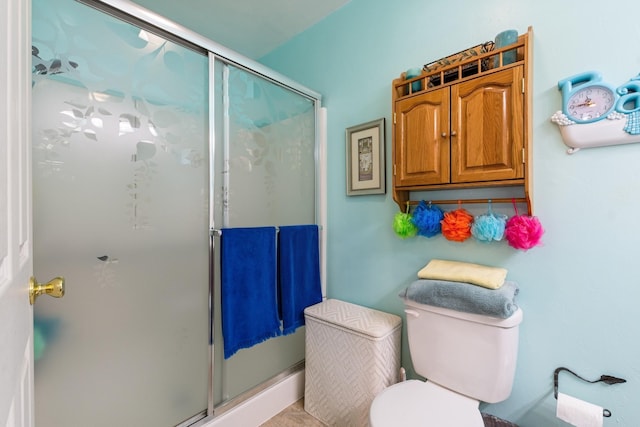 full bathroom with toilet and a shower stall