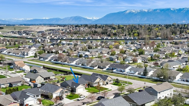 birds eye view of property with a mountain view and a residential view