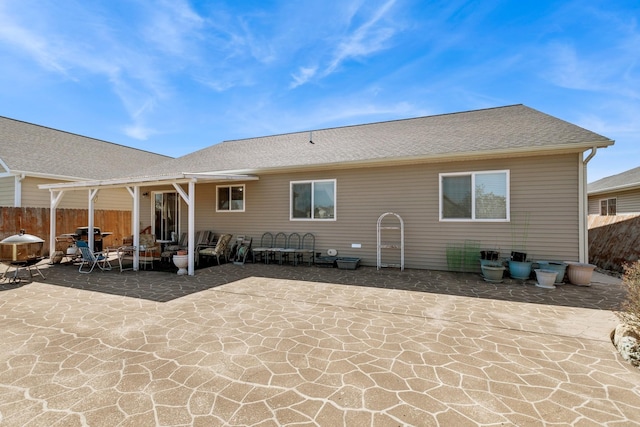 back of property with a patio area and fence