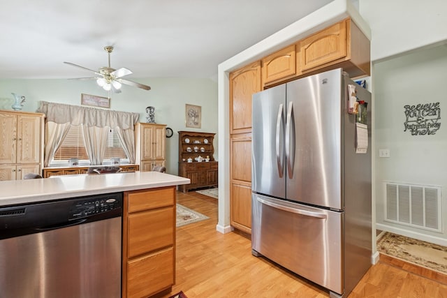 kitchen with a ceiling fan, light wood finished floors, stainless steel appliances, and visible vents