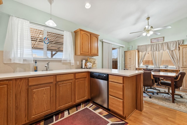 kitchen featuring a peninsula, a ceiling fan, a sink, dishwasher, and vaulted ceiling