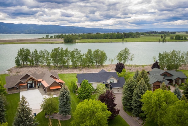 drone / aerial view featuring a water and mountain view