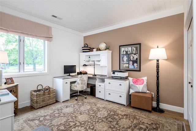home office featuring baseboards, visible vents, and wood finished floors