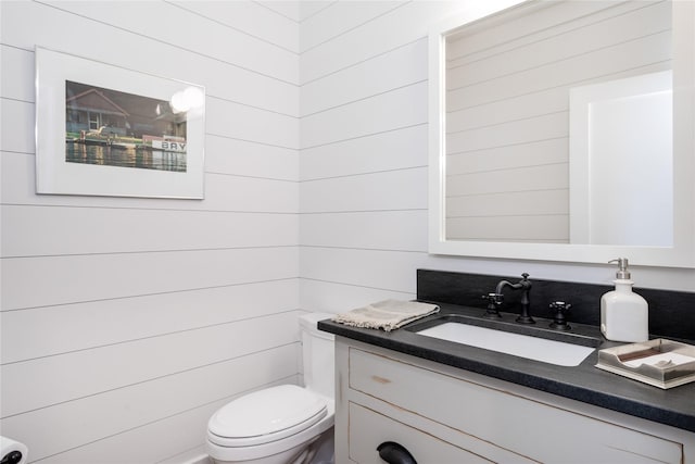 half bathroom with toilet and vanity