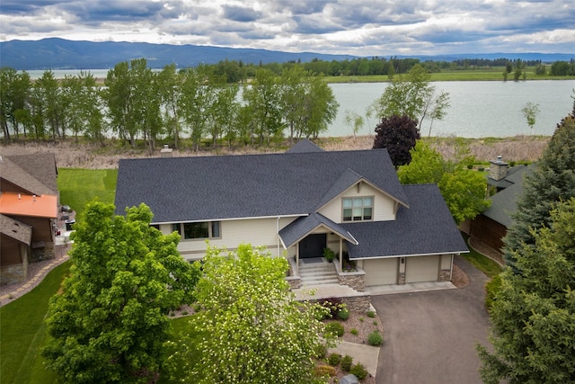 drone / aerial view featuring a water and mountain view