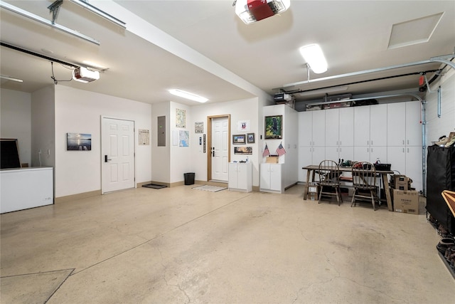 garage featuring electric panel and a garage door opener