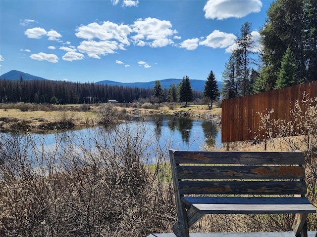 view of water feature featuring a mountain view and fence